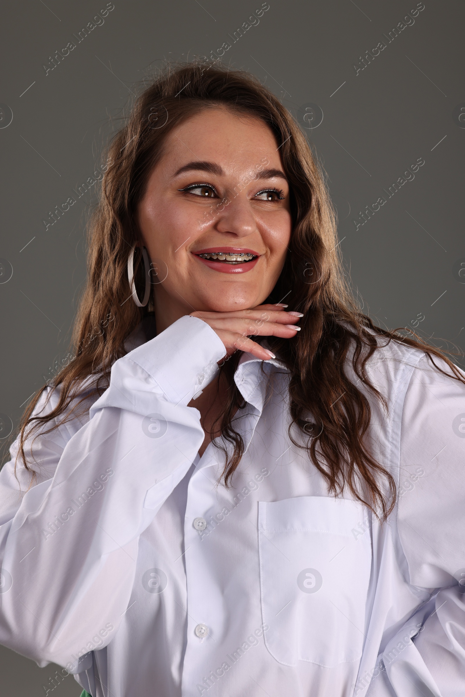 Photo of Portrait of beautiful woman on grey background