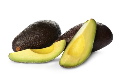 Photo of Cut and whole ripe avocadoes on white background