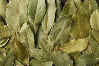 Photo of Aromatic bay leaves as background, top view