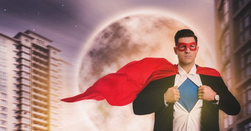 Image of Businessman in superhero cape and mask taking suit off against beautiful sky with full moon. Banner design