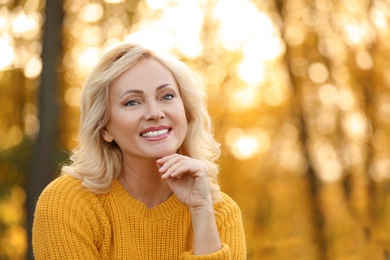 Photo of Portrait of happy mature woman in park