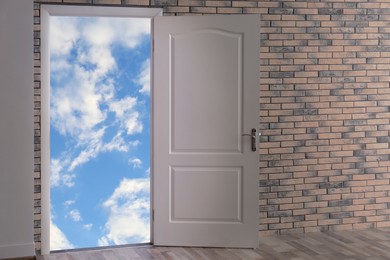 Image of Beautiful blue sky with fluffy clouds visible through open door