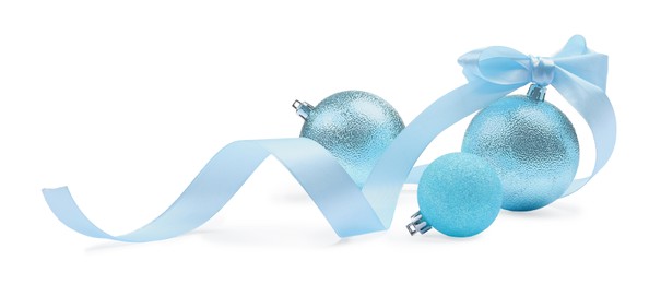 Photo of Beautiful Christmas balls and ribbon isolated on white