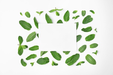 Flat lay composition with fresh green mint leaves on white background