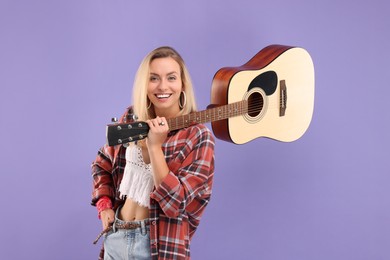 Photo of Happy hippie woman with guitar on purple background