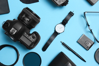 Photo of Flat lay composition with professional photographer equipment and accessories on color background