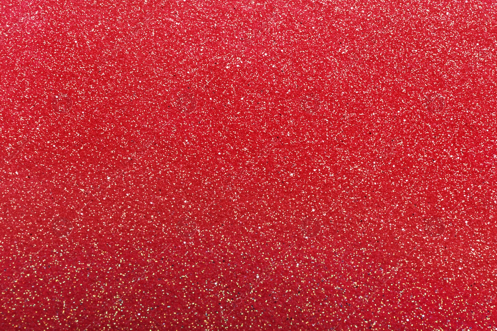 Photo of Closeup view of sparkling red glitter background