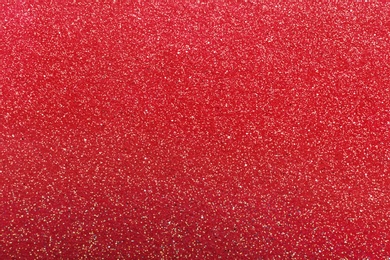 Photo of Closeup view of sparkling red glitter background