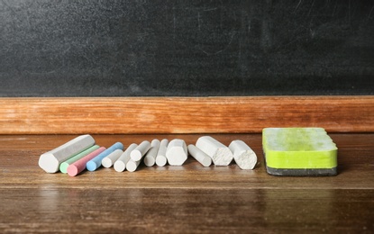 Chalk and duster on table in classroom