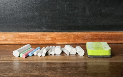 Photo of Chalk and duster on table in classroom