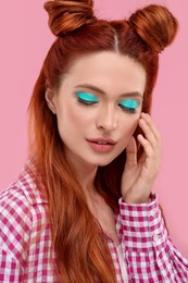Photo of Beautiful woman with bright makeup on pink background
