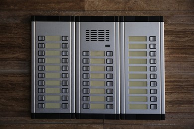 Photo of Modern intercom system on stone wall. House security