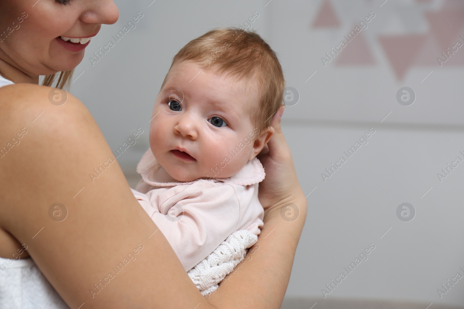 Photo of Young woman with her little baby resting after breast feeding at home, closeup