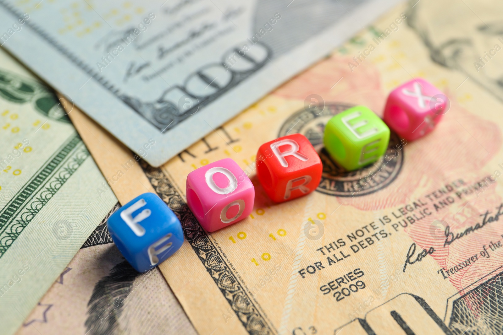 Photo of Word Forex made of colorful cubes with letters on banknotes, closeup