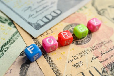 Photo of Word Forex made of colorful cubes with letters on banknotes, closeup