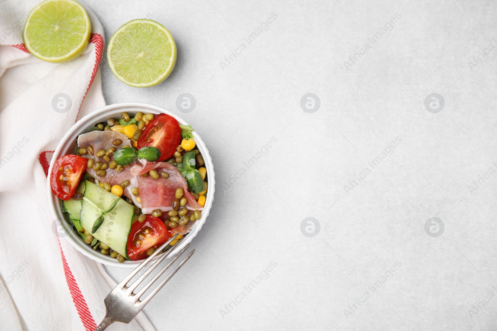 Photo of Bowl of salad with mung beans on white table, flat lay. Space for text