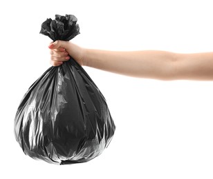 Photo of Woman holding plastic bag full of garbage on white background, closeup