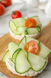 Photo of Puffed rice cakes with vegetables on table, closeup