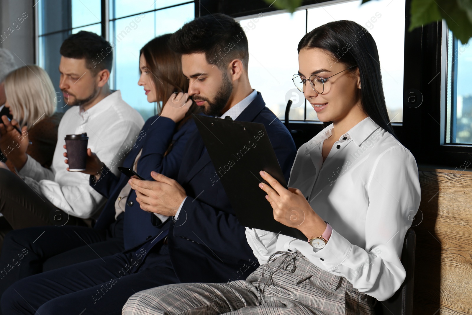 Photo of People waiting for job interview in office hall