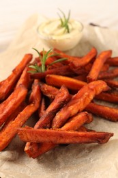Delicious sweet potato fries and sauce on table, closeup