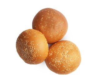 Photo of Fresh tasty buns with sesame seeds isolated on white, top view