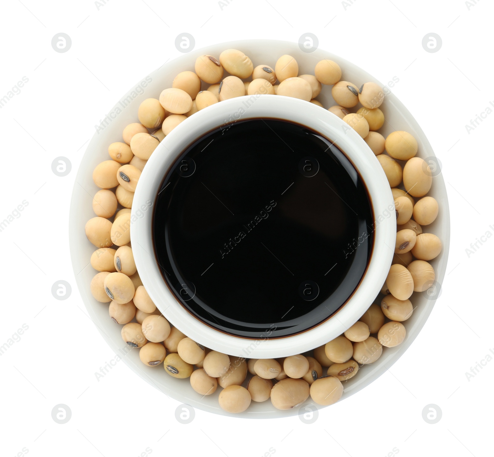 Photo of Dish of soy sauce with beans on white background, top view