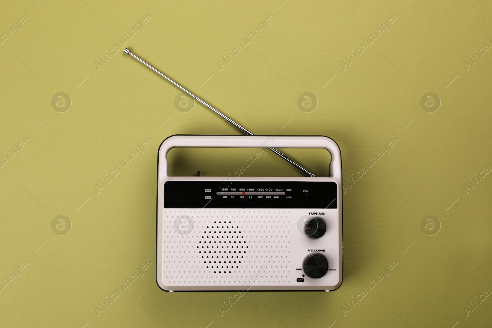 Photo of Retro radio receiver on light green background, top view