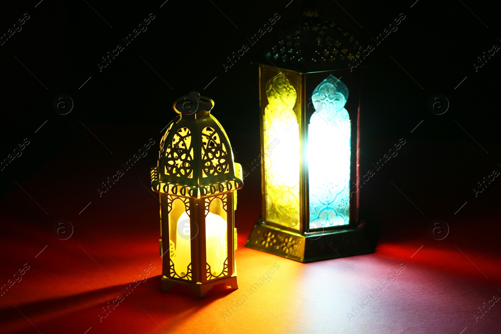 Photo of Decorative Arabic lanterns on table against dark background