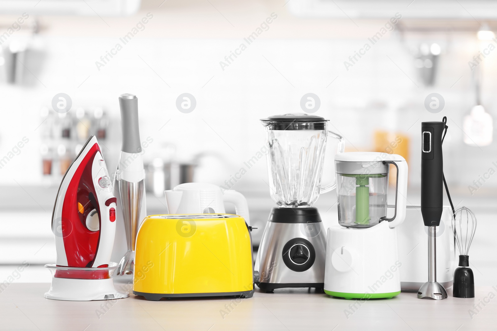 Photo of Household and kitchen appliances on table indoors. Interior element