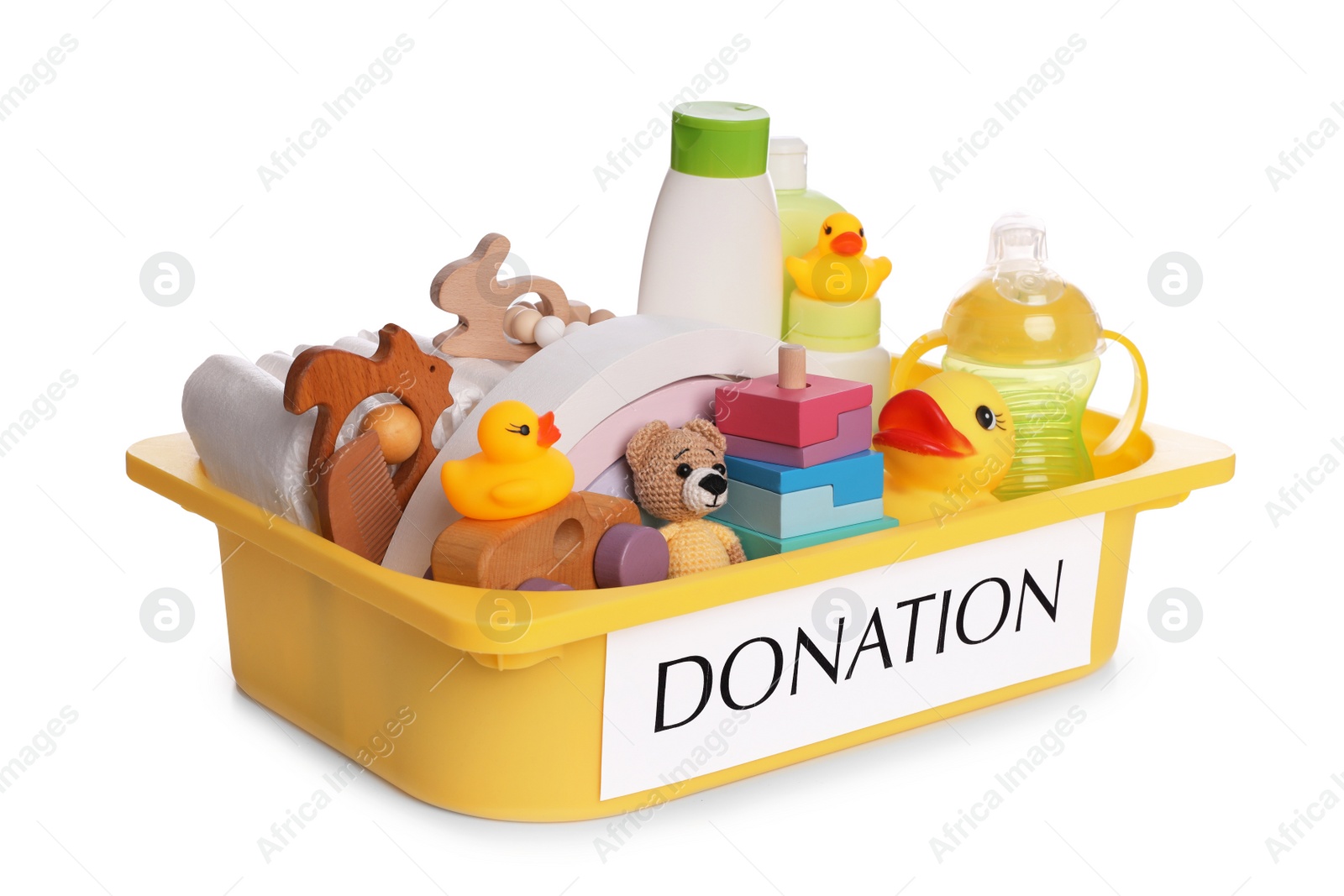 Photo of Donation box full of different toys and baby accessories isolated on white
