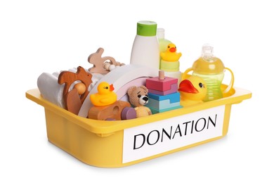 Photo of Donation box full of different toys and baby accessories isolated on white