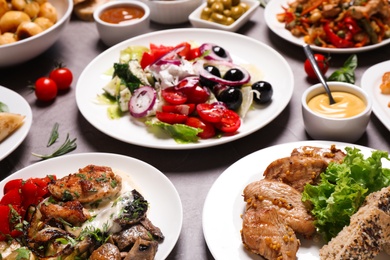 Photo of Buffet service. Many different dishes on grey table