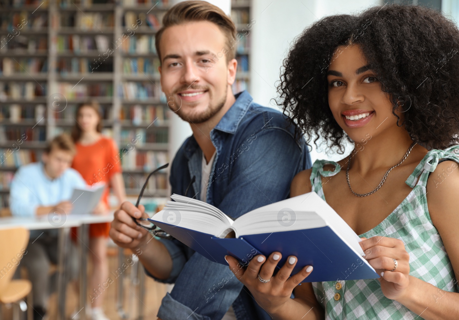 Photo of Young people studying together in modern library