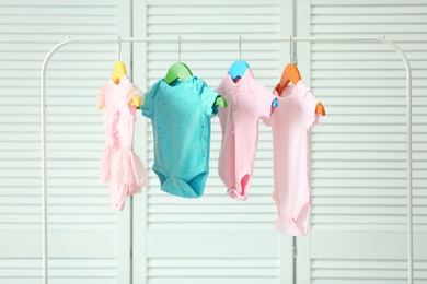 Baby clothes hanging on rack, indoors