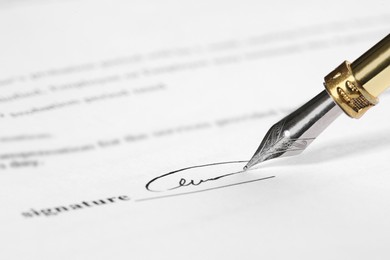 Photo of Signing notary document with fountain pen, closeup. Space for text