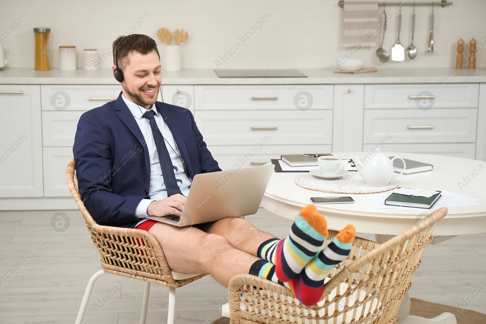 Photo of Businessman in underwear pretending to wear formal clothes during video call at home