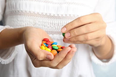 Woman holding many tasty glazed candies, closeup