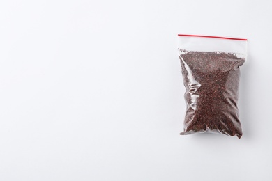 Photo of Plastic bag with spice on white background, top view