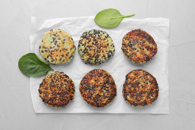 Photo of Delicious vegan cutlets with sesame on white table, top view