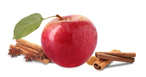 Aromatic cinnamon sticks, powder, anise stars and red apple isolated on white