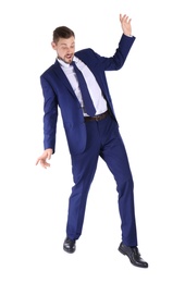 Photo of Full length portrait of businessman balancing on white background
