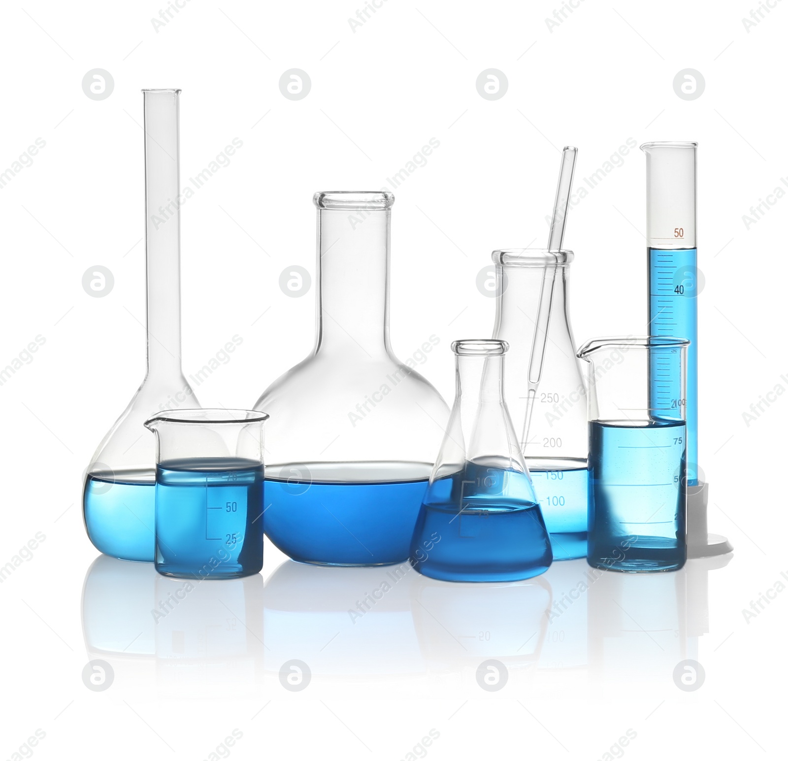 Photo of Different laboratory glassware with light blue liquid isolated on white