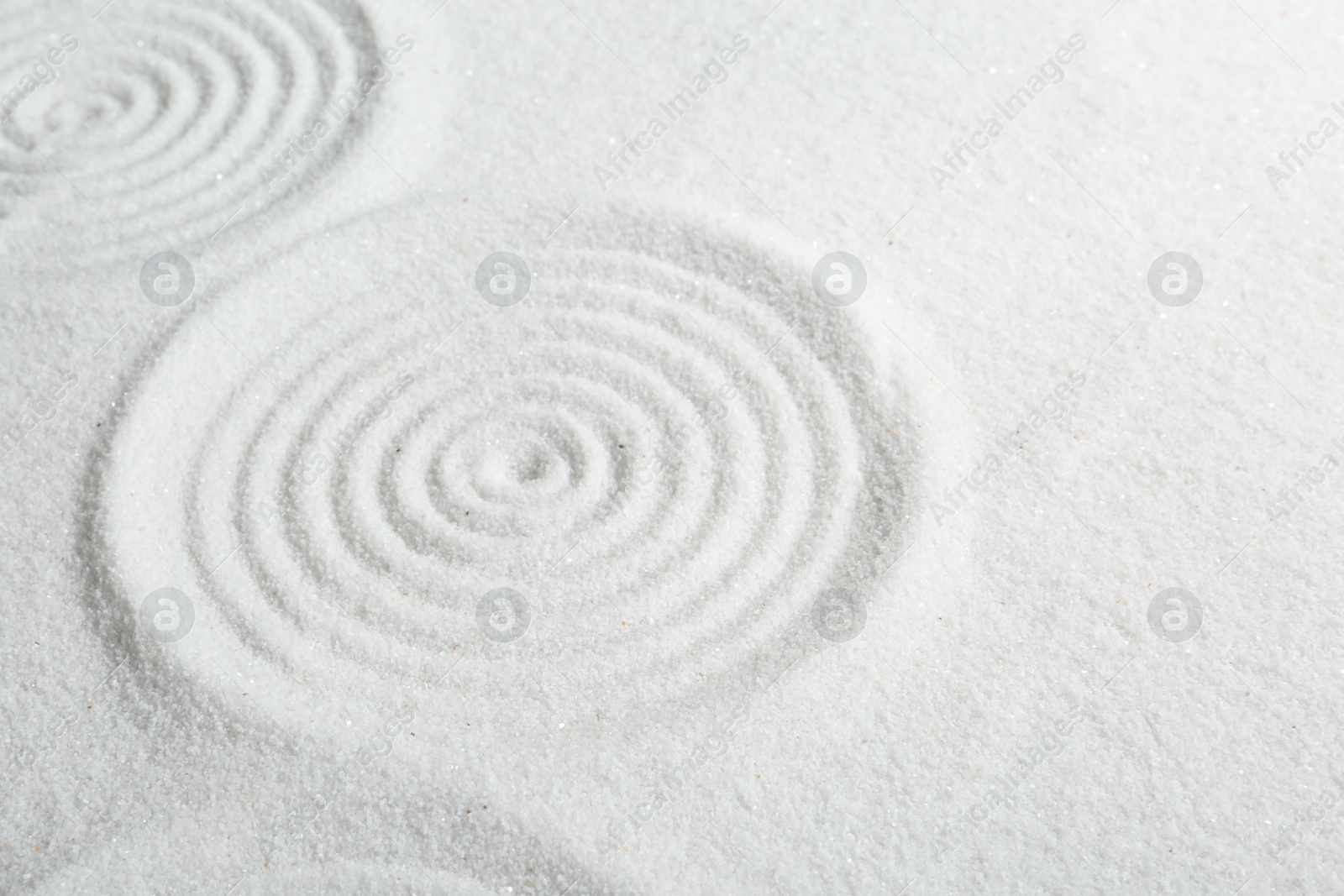 Photo of Zen rock garden. Circle patterns on white sand