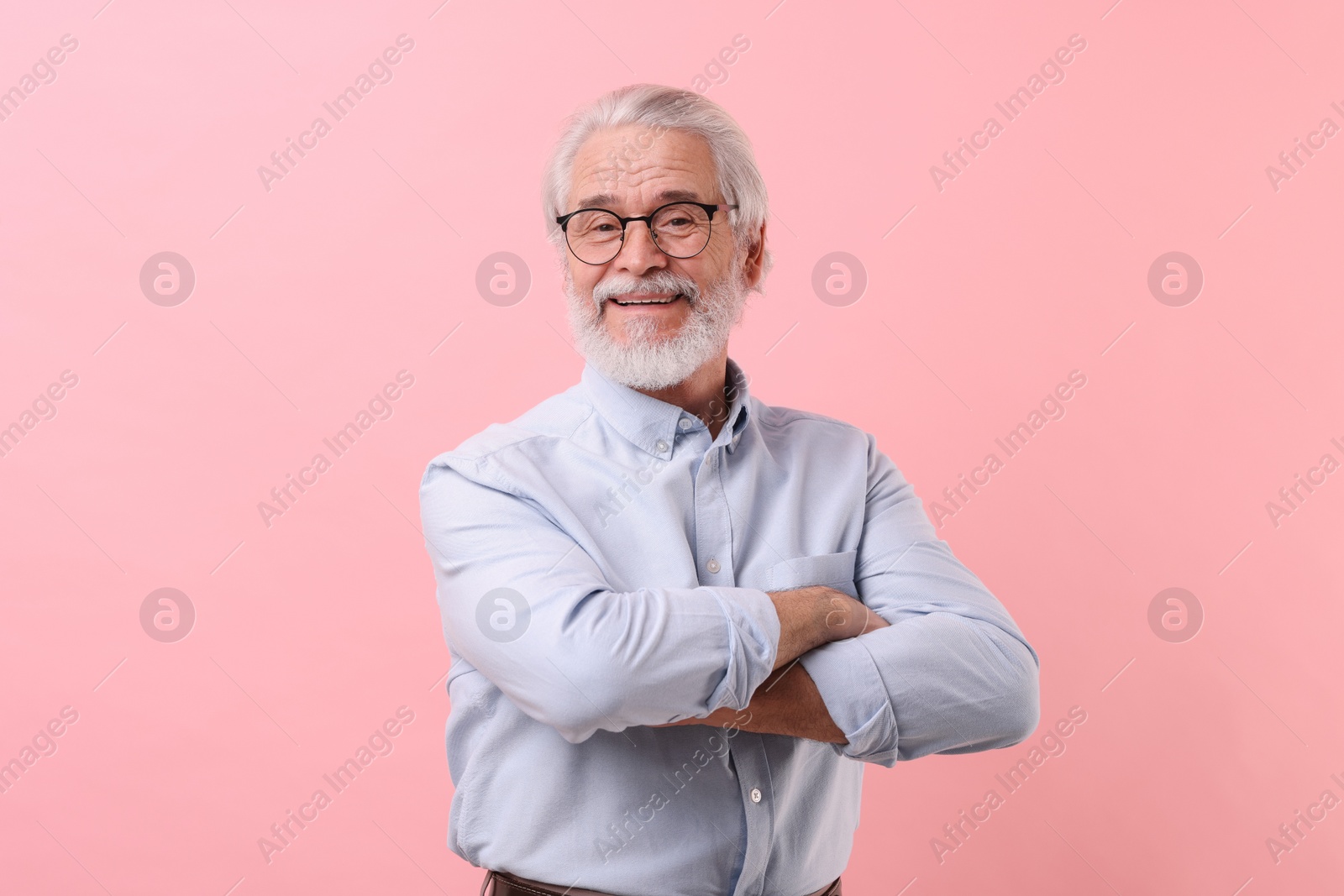 Photo of Portrait of stylish grandpa with glasses on pink background