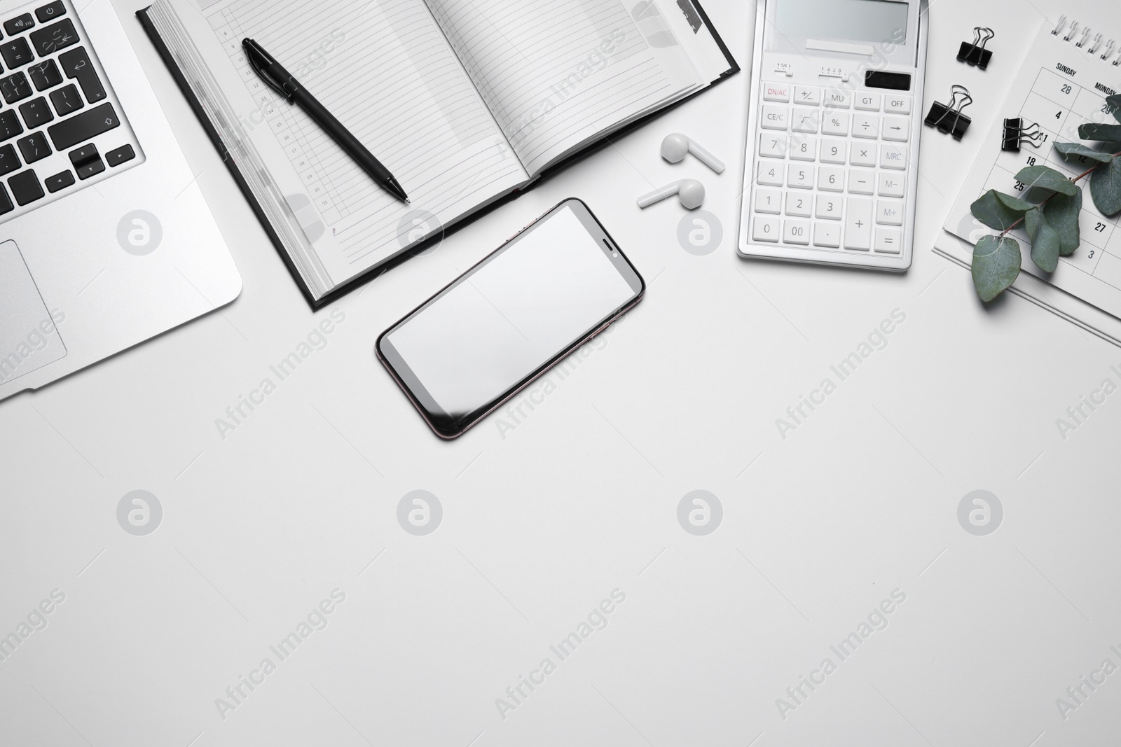 Photo of Laptop, smartphone and stationery on white background, flat lay. Space for text