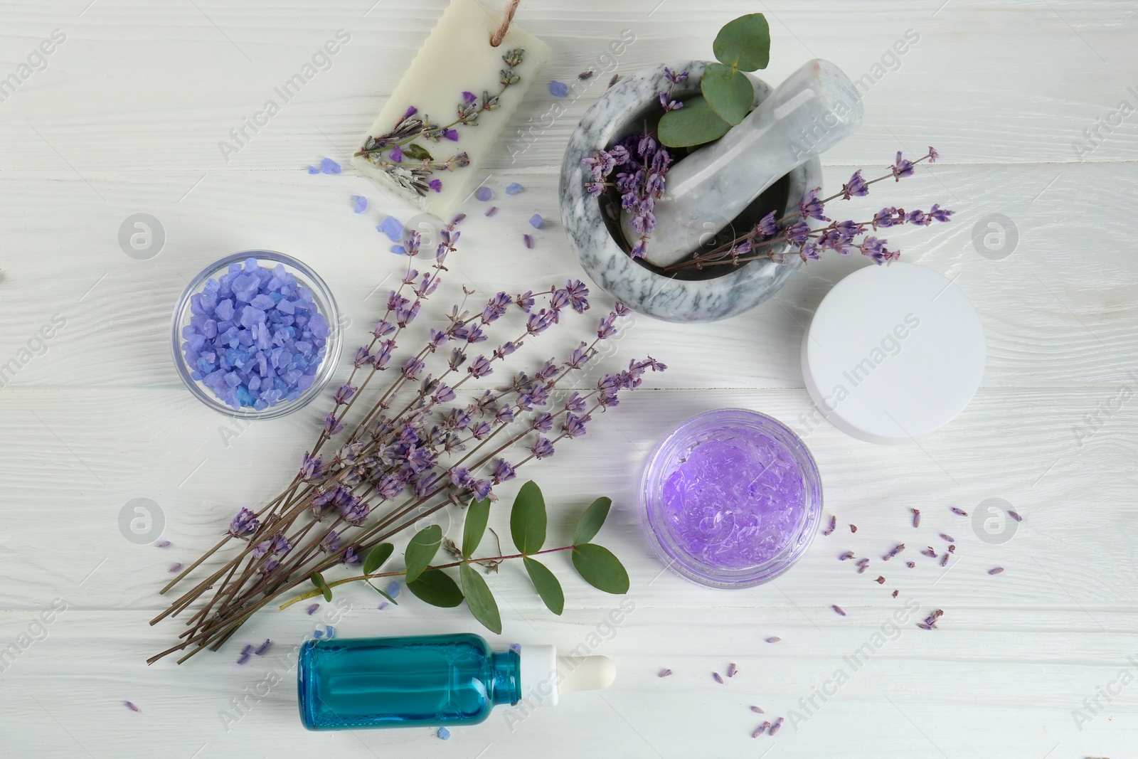 Photo of Homemade cosmetic products and fresh ingredients on white wooden table, flat lay