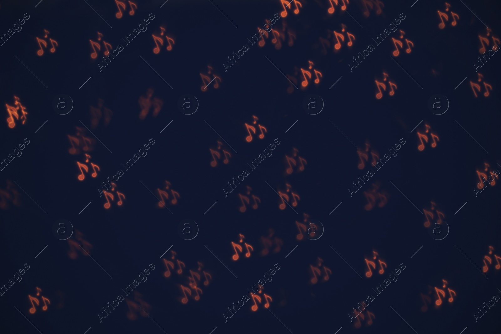 Photo of Blurred view of note shaped lights on dark background. Bokeh effect