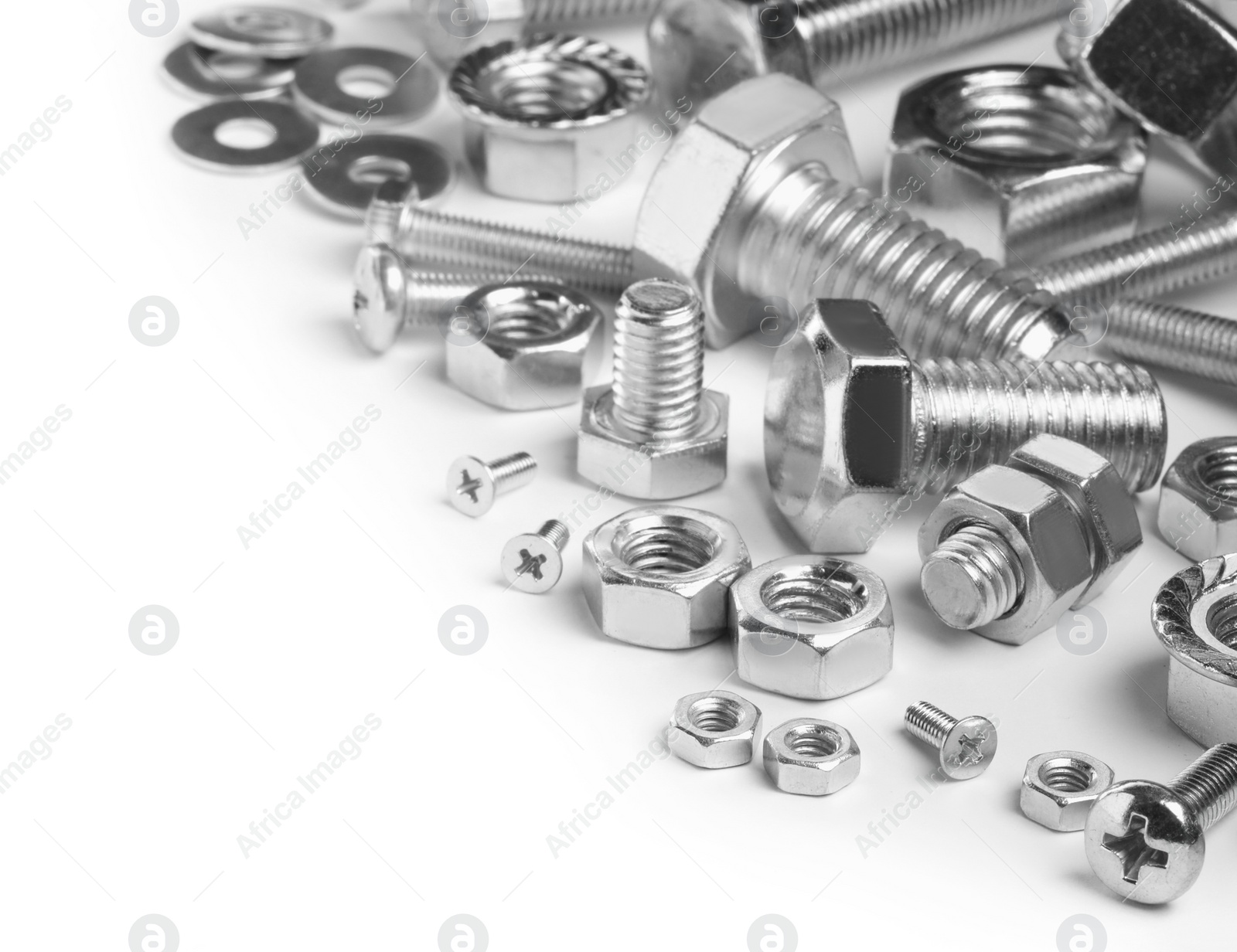 Photo of Different metal bolts and nuts on white background