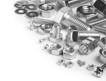 Photo of Different metal bolts and nuts on white background