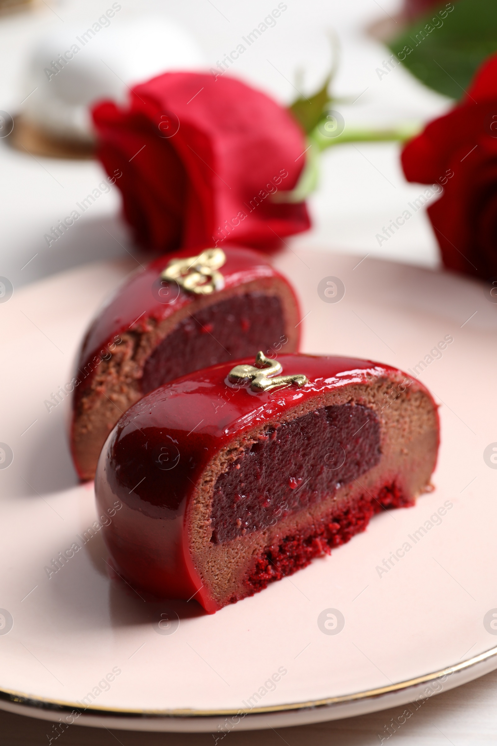 Photo of St. Valentine's Day. Pieces of delicious cake served on table, closeup